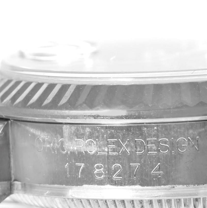 The image shows a close-up side view of a Mid-Size Rolex watch, focusing on the bezel and engraved model number.