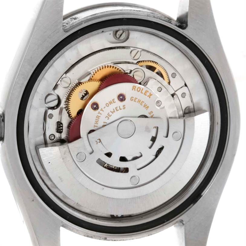 The image shows the back view of the Rolex Mid-Size 178274 Women's Stainless Steel Blue Dial 178274 Women's Stainless Steel Blue Dial model watch, displaying its internal movement and mechanisms.