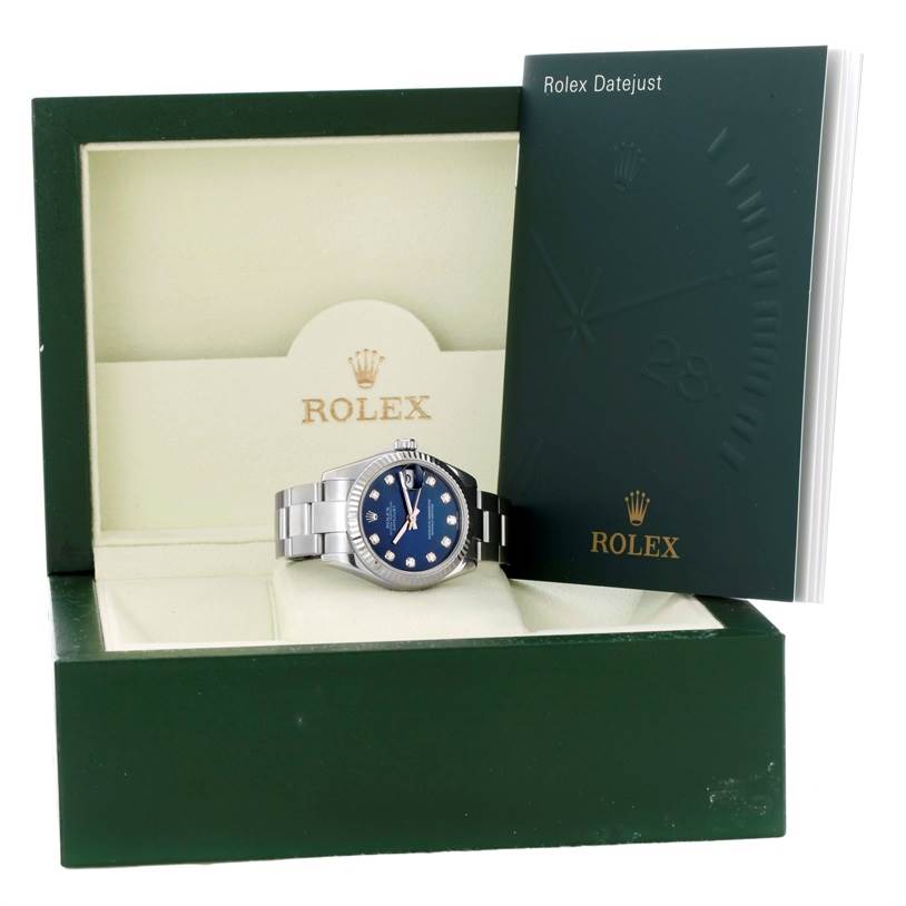 The Rolex Mid-Size 178274 Women's Stainless Steel Blue Dial 178274 Women's Stainless Steel Blue Dial watch is shown at a frontal angle, placed in its box with the Rolex Datejust booklet visible.