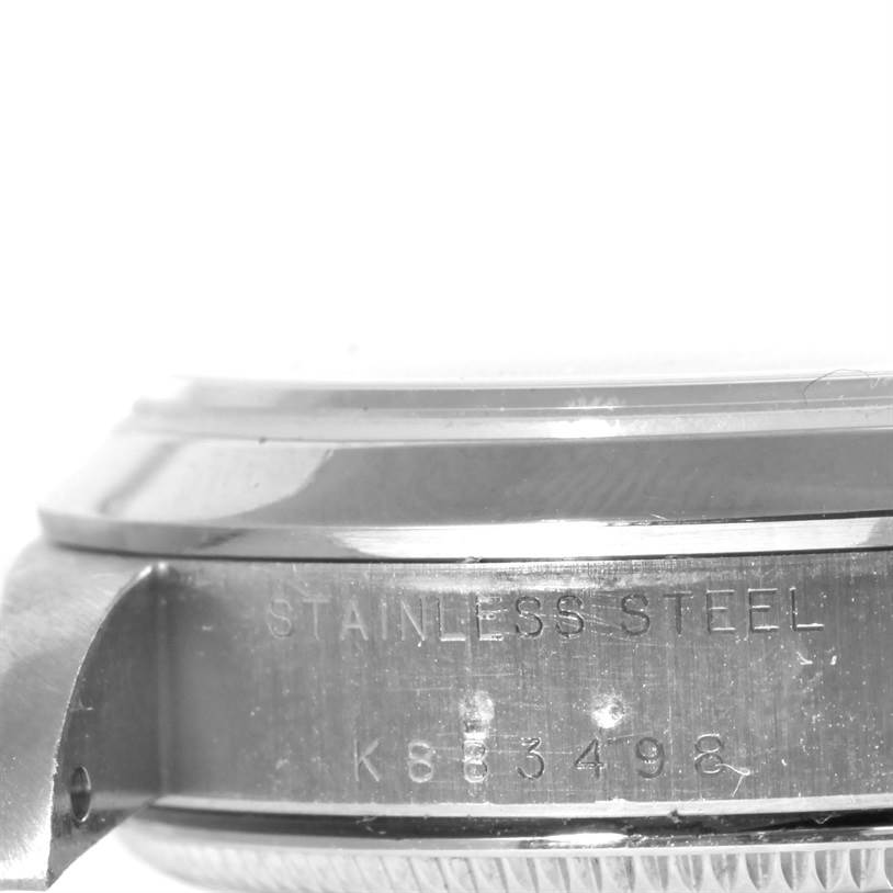 This image shows the side view of a Mid-Size Rolex watch case, highlighting the stainless steel material and serial number.