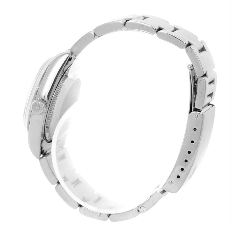 This image shows a side view of a Rolex Mid-Size 78240 Women's Stainless Steel Pink Dial 78240 Women's Stainless Steel Pink Dial watch, displaying the case, crown, and bracelet.