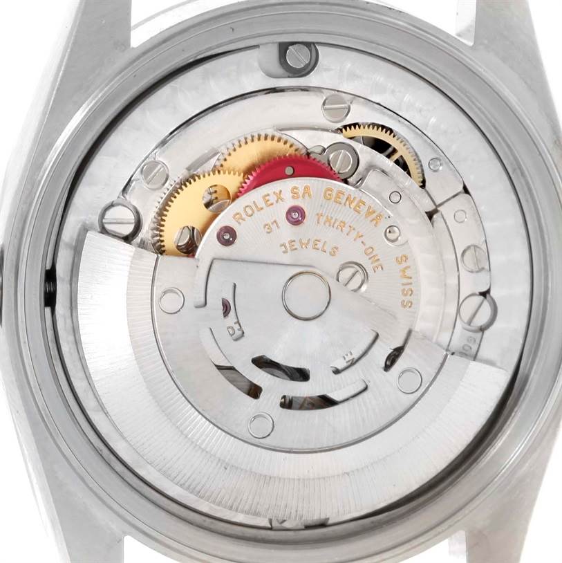 The image shows the internal mechanism of a Rolex Mid-Size 78240 Women's Stainless Steel Pink Dial 78240 Women's Stainless Steel Pink Dial watch viewed from the back, highlighting gears and engravings.