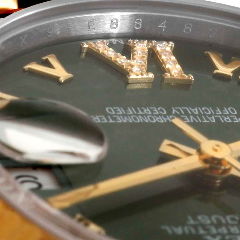The image shows a close-up angle of the face of a Rolex Mid-Size 178273 Women's Steel and Gold (two tone) Green Dial 178273 Women's Steel and Gold (two tone) Green Dial watch, highlighting the "VI" numeral and part of the date magnifier.