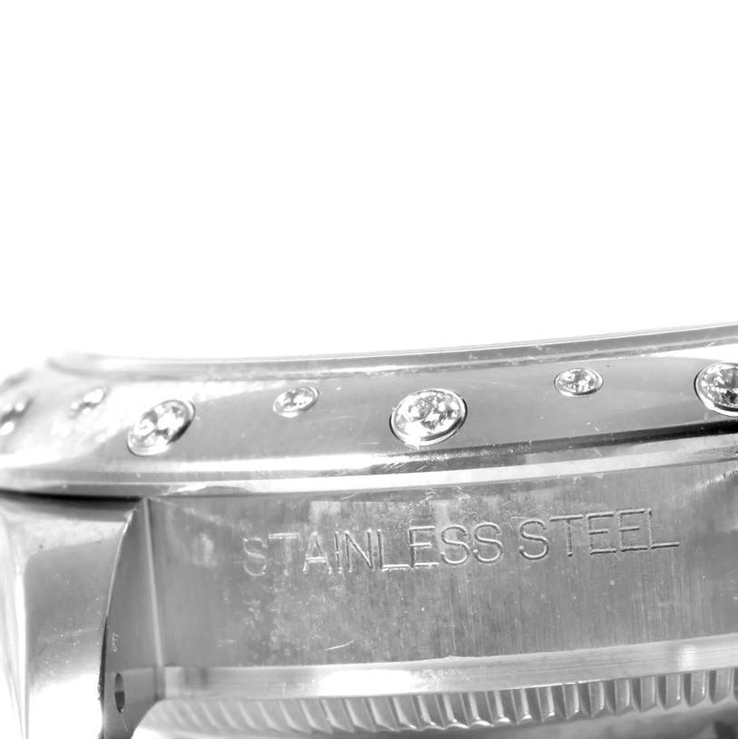 The image shows a close-up of the side view of the bezel and case back of a Rolex Mid-Size 178344 Women's Stainless Steel Mother of Pearl Dial 178344 Women's Stainless Steel Mother of Pearl Dial watch, highlighting its stainless steel construction and embedded gems.