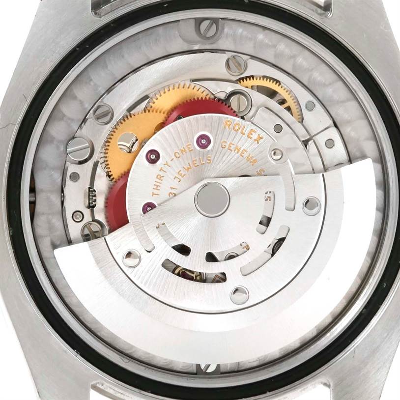 The image shows the internal movement parts of a Mid-Size Rolex watch, viewed from the back.