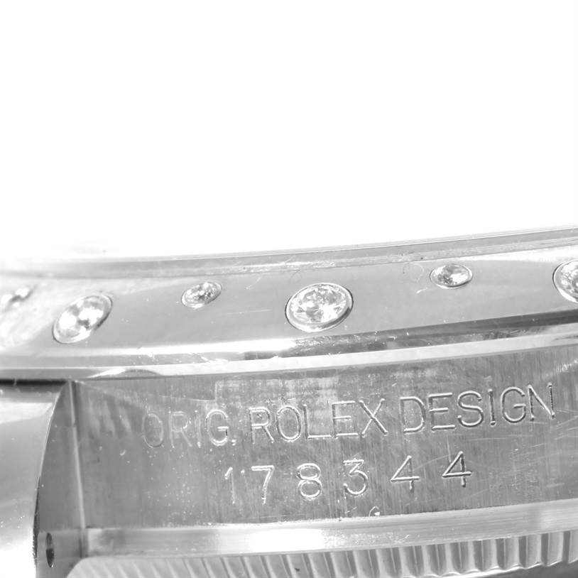 This close-up angle of the Mid-Size Rolex watch shows part of the bezel and the engraved "ORIG. ROLEX DESIGN" with the model number 178344.