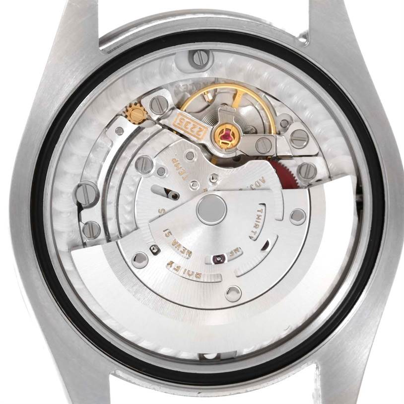The image shows the inside movement mechanism of a Mid-Size Rolex watch from a top-down angle.
