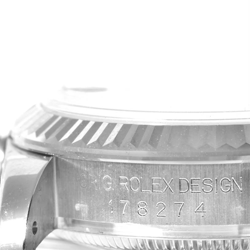 This image shows a side view of the bezel and case of a Rolex Mid-Size 178274 Women's Stainless Steel Pink Dial 178274 Women's Stainless Steel Pink Dial watch, displaying the model number and "ORIG ROLEX DESIGN" engraving.