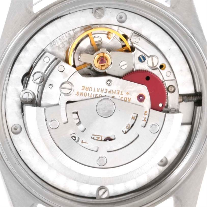 The image shows the inner mechanics of the back of a mid-size Rolex watch model.