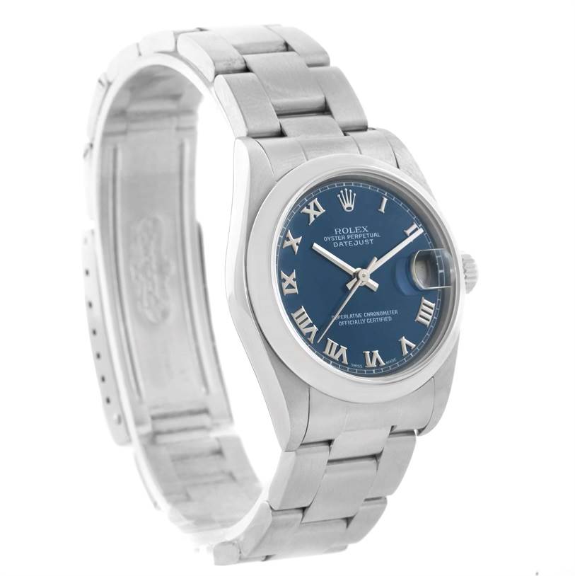 The image shows a Rolex Datejust Mid-Size model from a front angle displaying its blue dial, Roman numerals, and stainless steel bracelet.