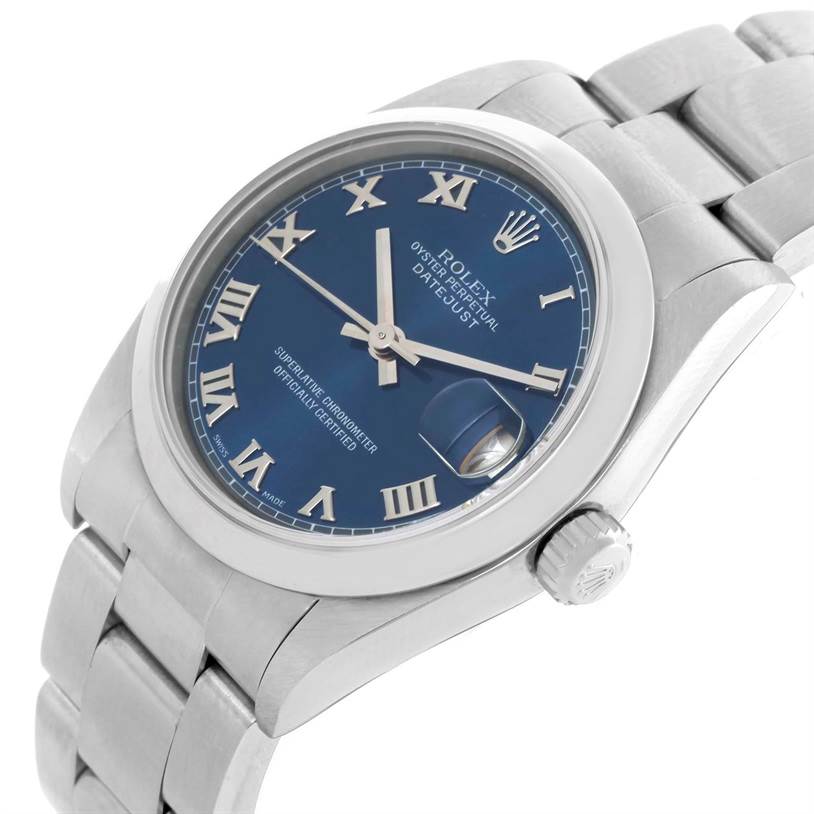 This image shows a Rolex Mid-Size 68240 Women's Stainless Steel Blue Dial 68240 Women's Stainless Steel Blue Dial Datejust watch from a slightly tilted angle displaying its blue dial, Roman numerals, and metal bracelet.