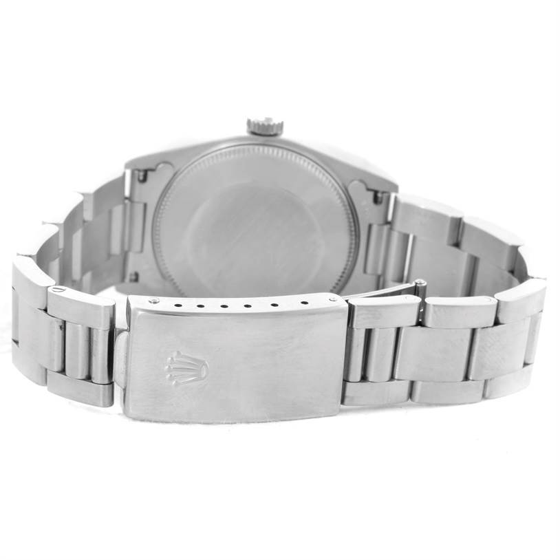 The image shows the back and clasp of a Rolex Mid-Size 68240 Women's Stainless Steel Blue Dial 68240 Women's Stainless Steel Blue Dial model, featuring its metallic bracelet and closed case back.