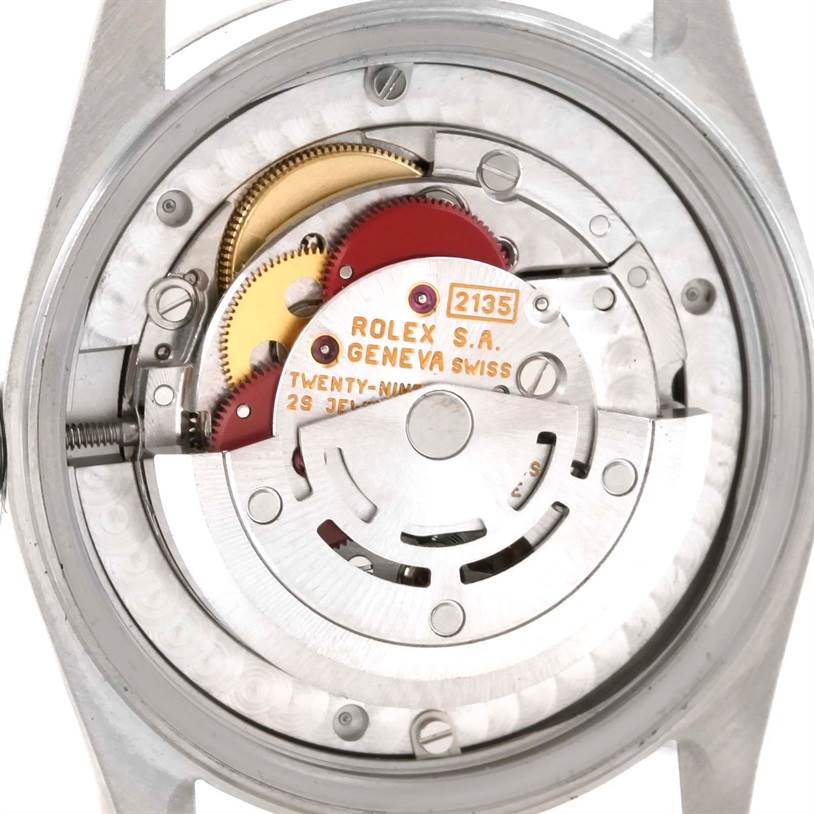 The image shows the internal mechanism of a Mid-Size Rolex watch, focused on the movement components.