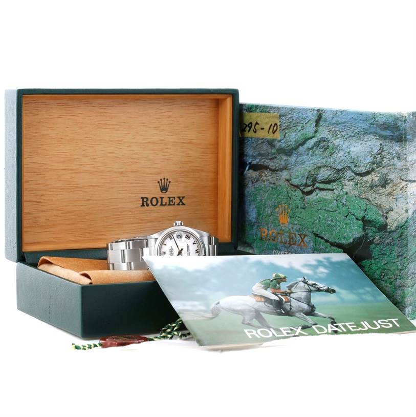 The Rolex Mid-Size 68240 Women's Stainless Steel White Dial 68240 Women's Stainless Steel White Dial watch is shown partially in its green and wooden box with the brand's booklet and packaging visible.