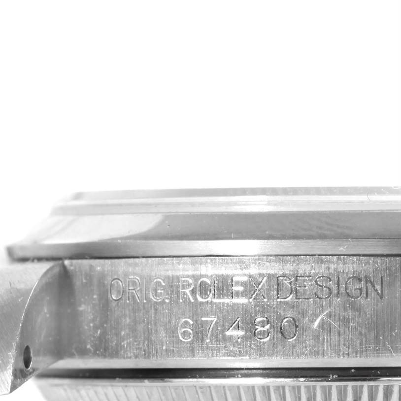 This image shows a side view of the casing of a Mid-Size Rolex watch, with the engraving "ORIG ROLEX DESIGN 67480".