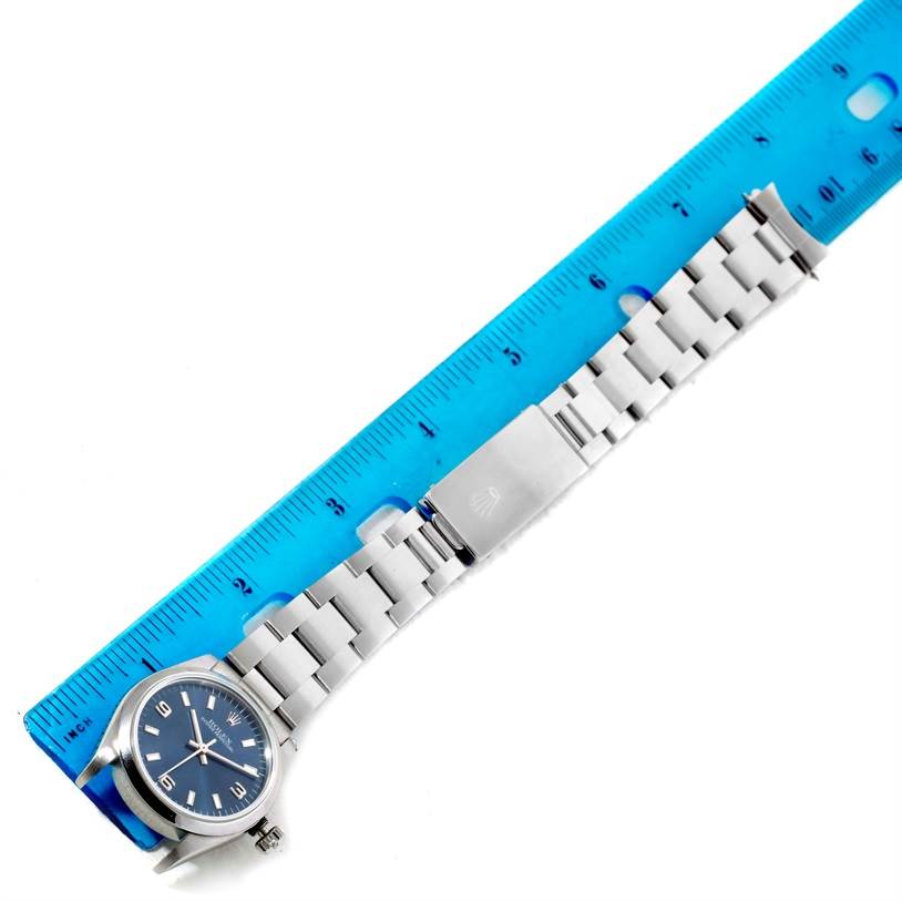 The image shows a Rolex Mid-Size 67480 Women's Stainless Steel Blue Dial 67480 Women's Stainless Steel Blue Dial watch lying flat with its face, bracelet, and clasp fully visible, next to a ruler for scale.