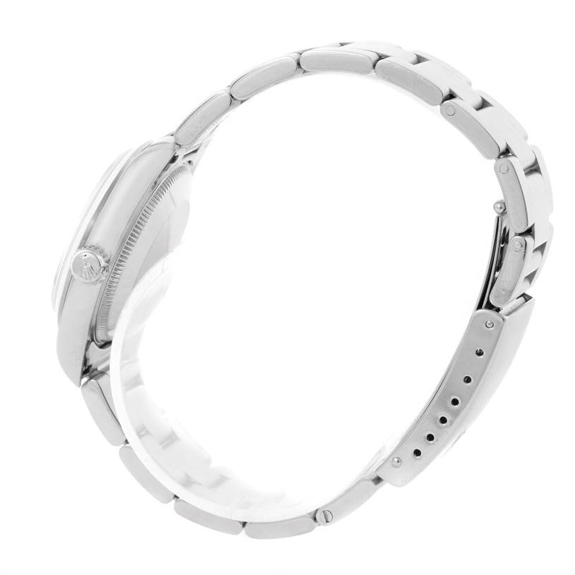 This image shows a side view of a Rolex Mid-Size 67480 Women's Stainless Steel Blue Dial 67480 Women's Stainless Steel Blue Dial model watch featuring its bracelet and clasp.