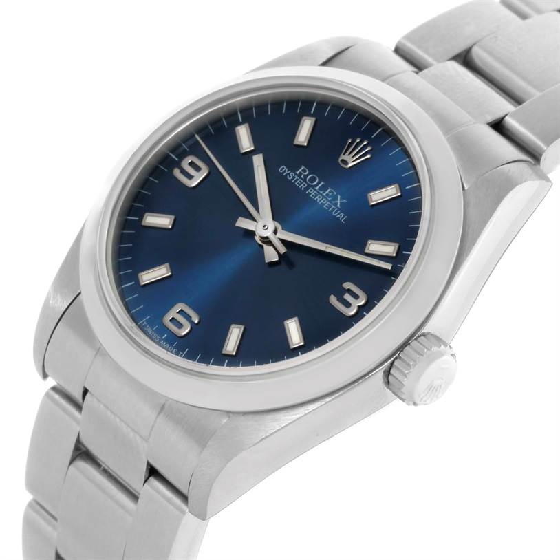 This image shows a Rolex Oyster Perpetual Mid-Size watch from a front-top angle, highlighting the blue dial, silver bracelet, and crown.