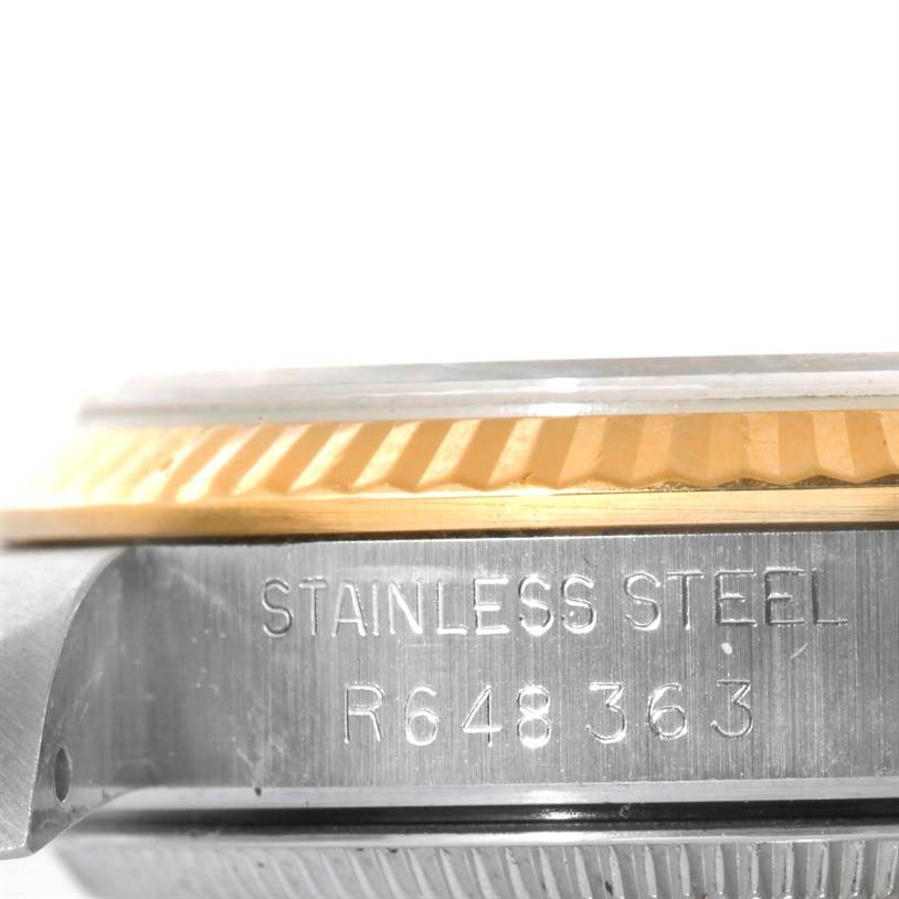 This image shows the side angle of the bezel and case of a mid-size Rolex, highlighting the stainless steel and model number.