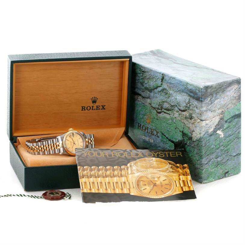 The image shows a Rolex Mid-Size 68273 Women's Steel and Gold (two tone) Champagne Dial 68273 Women's Steel and Gold (two tone) Champagne Dial watch in its display box with a booklet and packaging.