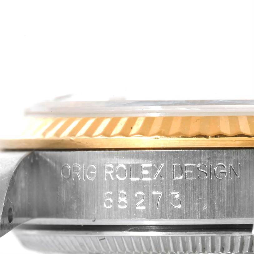 This image shows a side view of the Rolex Mid-Size 68273 Women's Steel and Gold (two tone) Champagne Dial 68273 Women's Steel and Gold (two tone) Champagne Dial watch with the model number 68273 engraved on its case.