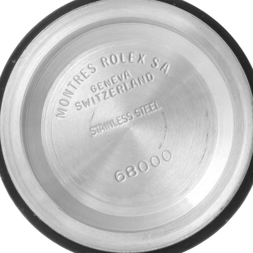 The image shows the stainless steel case back of a mid-size Rolex model, showcasing the brand name and model number 68000.