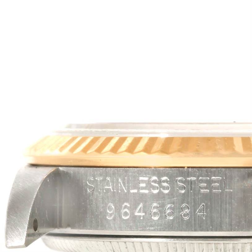 The image shows a close-up side view of a mid-size Rolex watch, highlighting the case's stainless steel material and serial number.