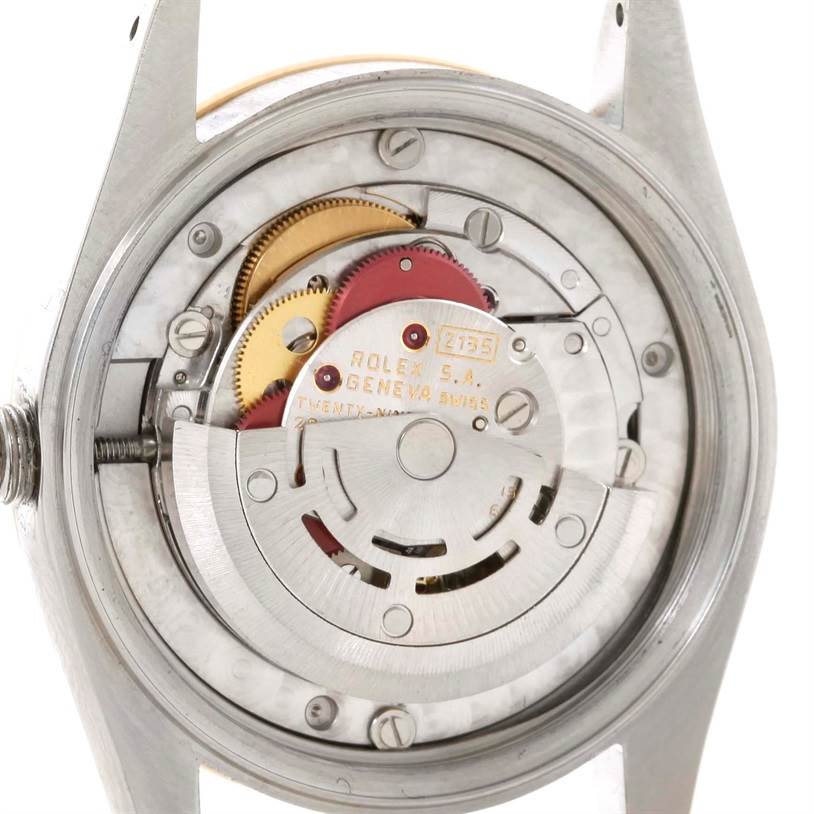 The image shows the back view of the internal mechanism of a Rolex Mid-Size 68273 Women's Steel and Gold (two tone) Champagne Dial 68273 Women's Steel and Gold (two tone) Champagne Dial model watch, revealing gears and movement components.
