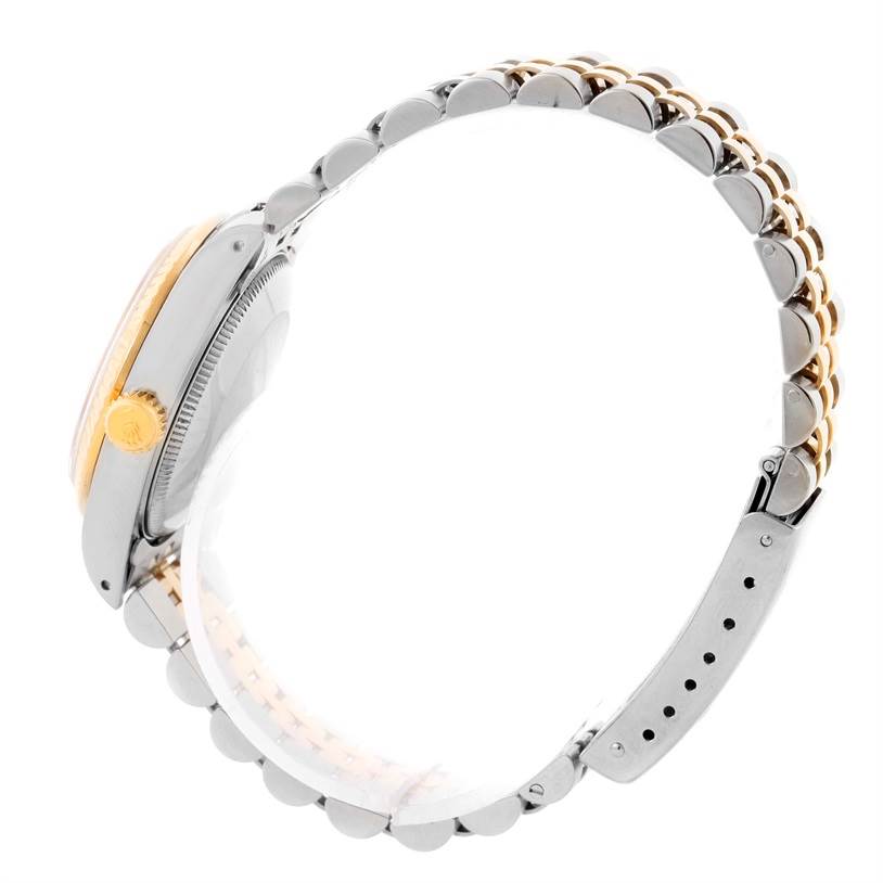 The image shows a side view of a Rolex Mid-Size 68273 Women's Steel and Gold (two tone) Champagne Dial 68273 Women's Steel and Gold (two tone) Champagne Dial model watch, highlighting the crown and bicolored bracelet.