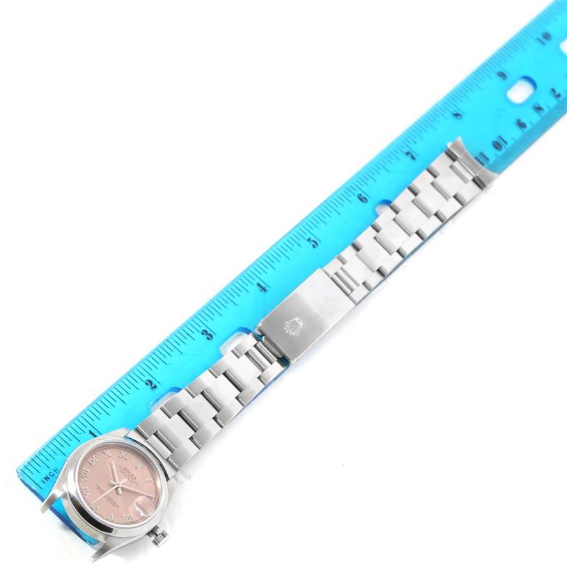 The image shows a top-down view of a Mid-Size Rolex watch alongside a measuring ruler.