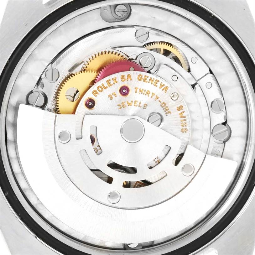 The image shows a close-up of the movement and internal mechanisms of a Mid-Size Rolex watch.