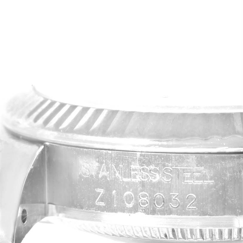 This image shows a close-up of the stainless steel case and serial number of a Mid-Size Rolex watch.
