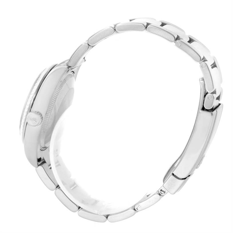 The image shows the side profile and bracelet of a Mid-Size Rolex watch, highlighting the crown and clasp.