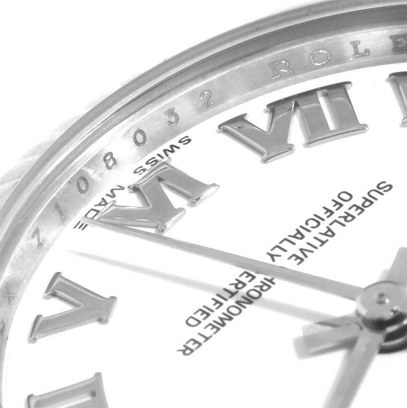 This close-up angle of a Rolex Mid-Size 178274 Women's Stainless Steel White Dial 178274 Women's Stainless Steel White Dial model watch showcases part of the dial with Roman numerals and text indicating "Swiss Made."