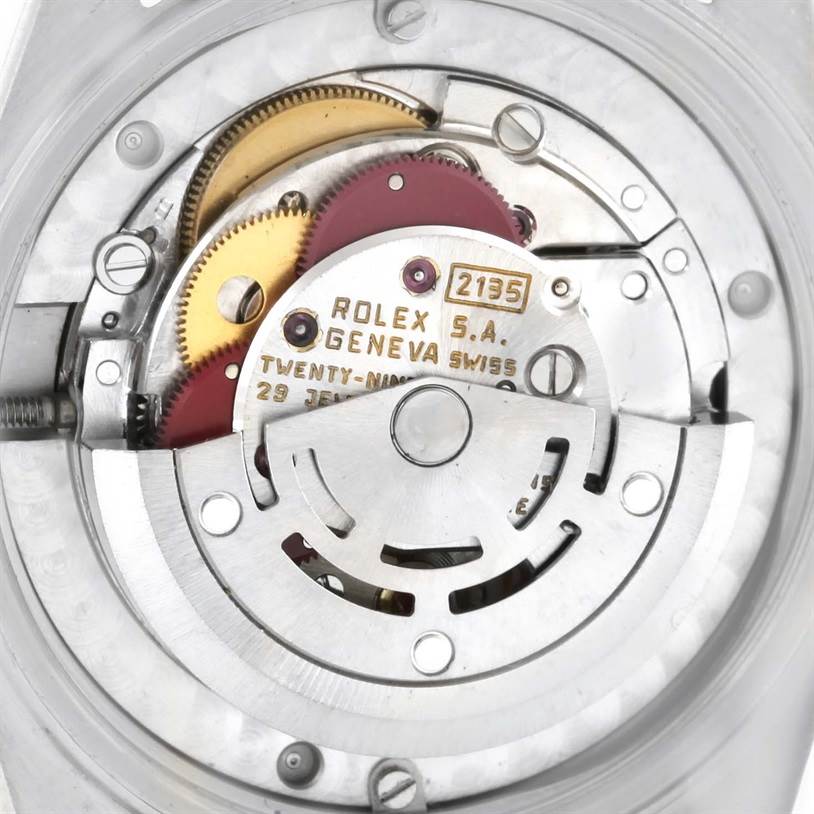 This image shows the inner mechanical movement of a Rolex Mid-Size 68273 Women's Steel and Gold (two tone) Champagne Dial 68273 Women's Steel and Gold (two tone) Champagne Dial model watch, featuring gears and the oscillating weight.