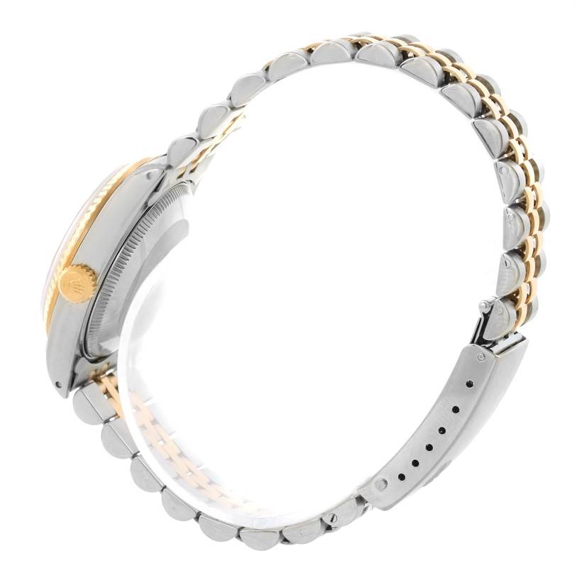 This image shows a side view of a Rolex Mid-Size 68273 Women's Steel and Gold (two tone) Champagne Dial 68273 Women's Steel and Gold (two tone) Champagne Dial watch, highlighting the crown and part of the two-tone bracelet.