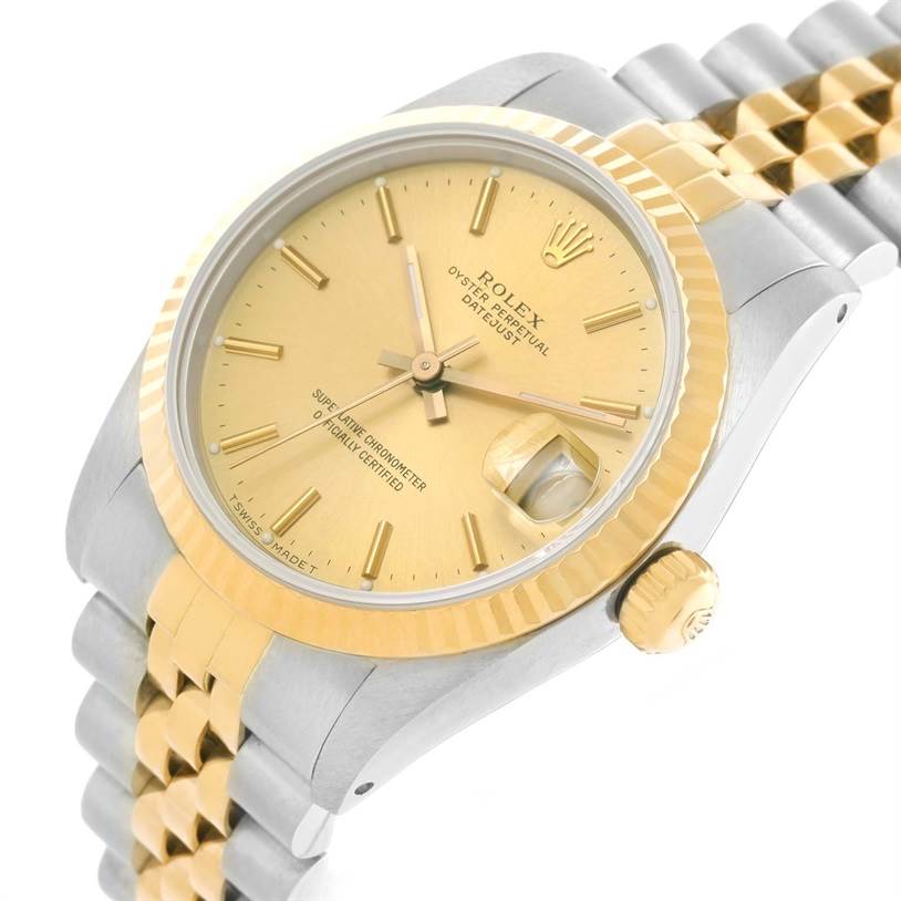 The image shows a Rolex Mid-Size 68273 Women's Steel and Gold (two tone) Champagne Dial 68273 Women's Steel and Gold (two tone) Champagne Dial watch from an angled view, highlighting its gold dial, fluted bezel, and two-tone metal bracelet.