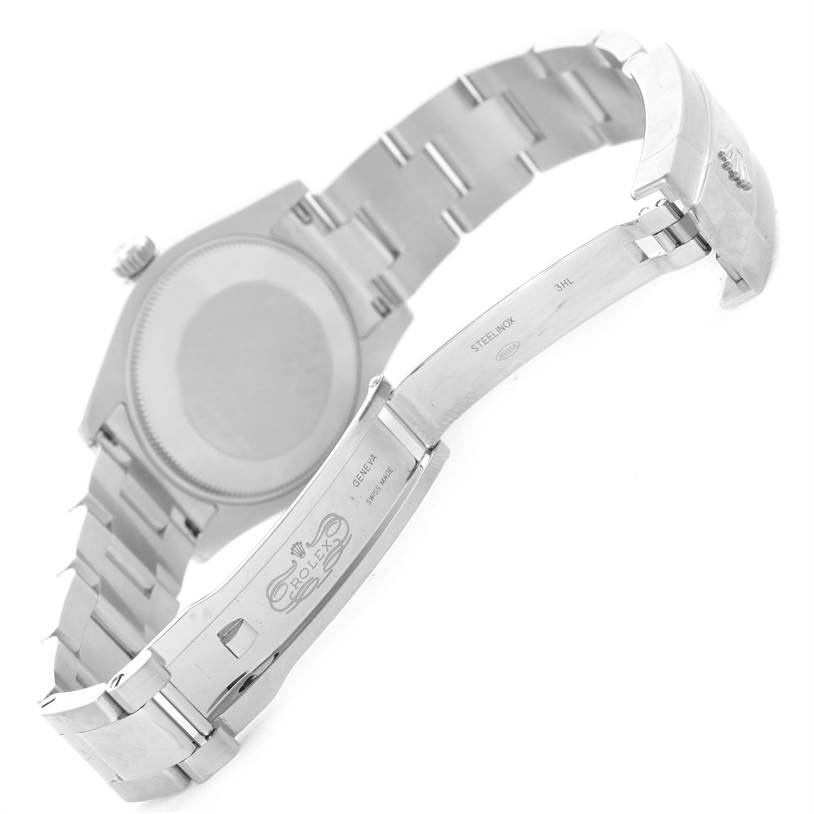 The image shows the underside and open clasp of a Mid-Size Rolex watch, focusing on the bracelet and case back.