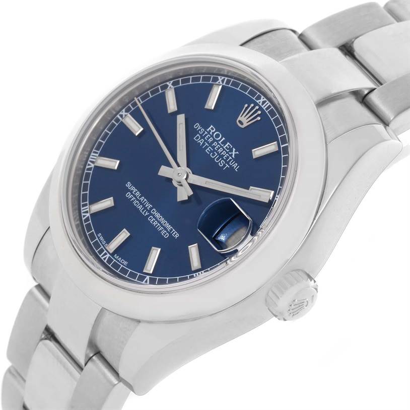 The image shows a Rolex Oyster Perpetual Datejust Mid-Size watch at an angled close-up view, highlighting its blue dial and stainless steel bracelet.