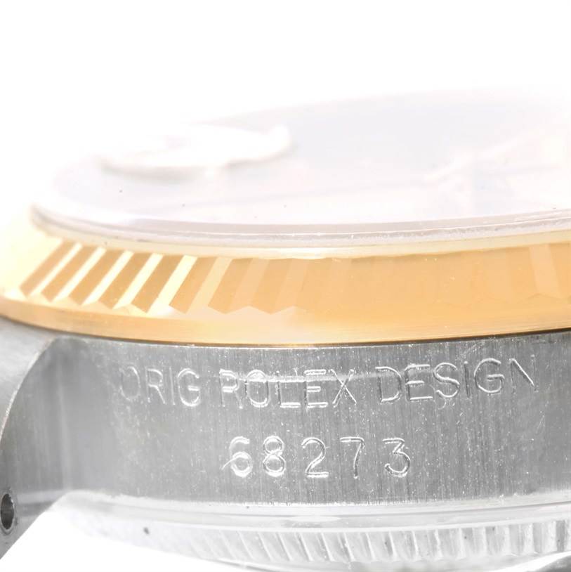 This image shows a close-up side view of a Mid-Size Rolex watch, emphasizing its bezel and engraved model number 68273.