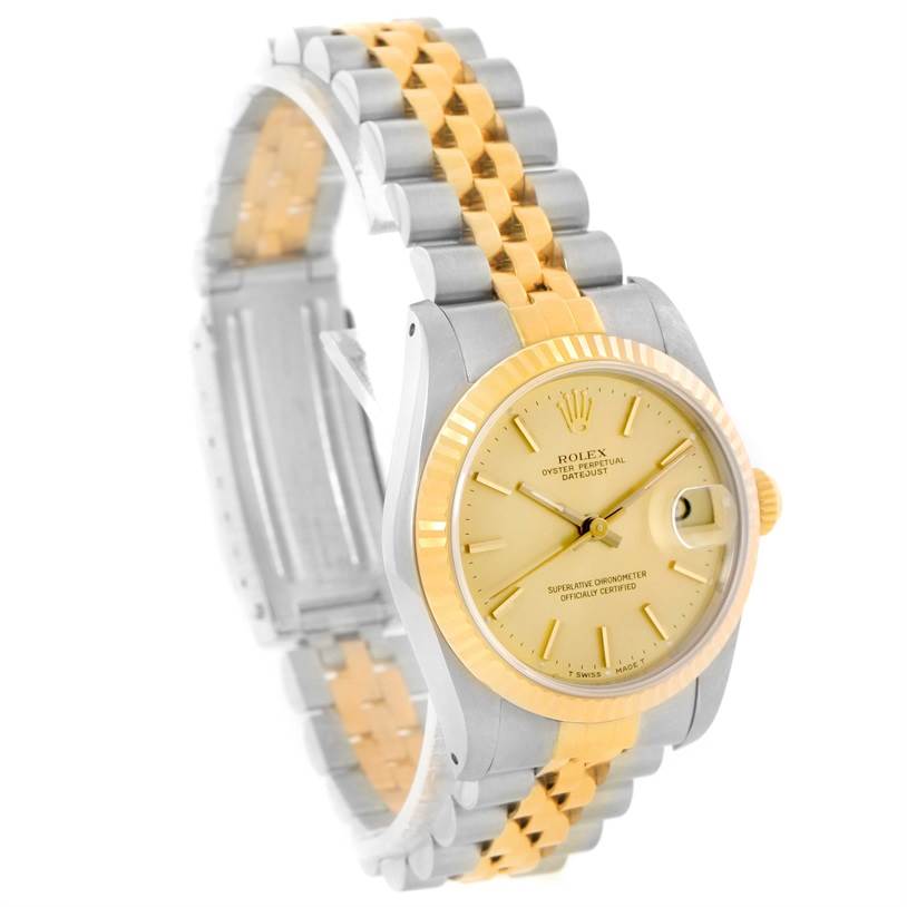 The Mid-Size Rolex watch is shown at a tilted angle, highlighting the dial, bezel, and bracelet.