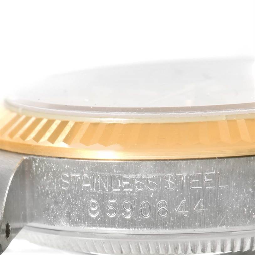 This image shows a close-up of a Rolex Mid-Size 68273 Women's Steel and Gold (two tone) Champagne Dial 68273 Women's Steel and Gold (two tone) Champagne Dial model watch, focusing on the side, bezel, and case with serial number visible.