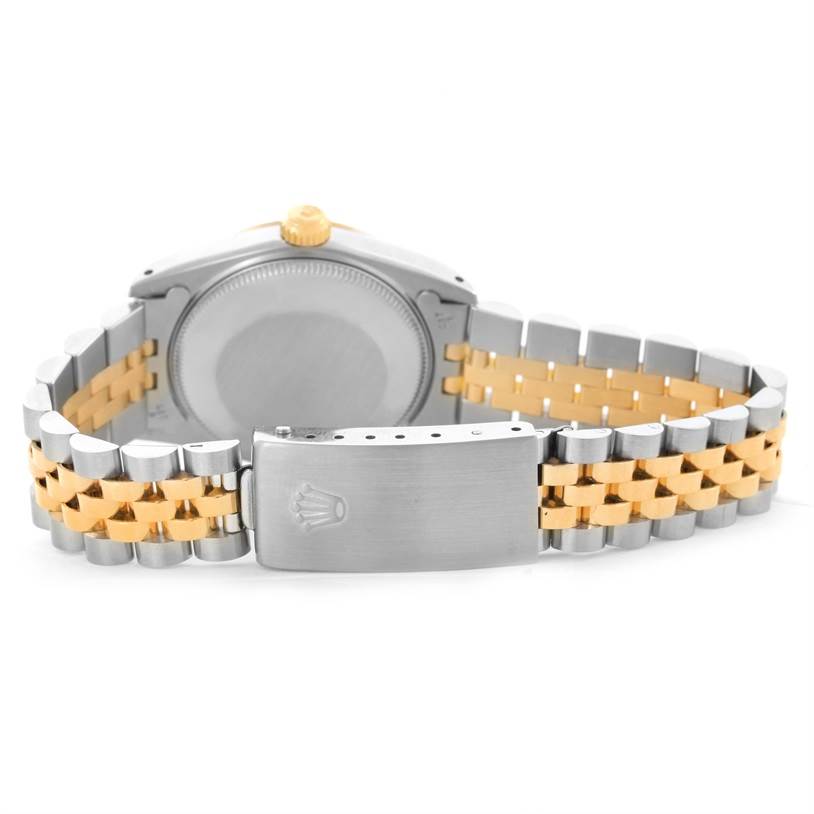 This image shows the back case and clasp of a Rolex Mid-Size 68273 Women's Steel and Gold (two tone) Champagne Dial 68273 Women's Steel and Gold (two tone) Champagne Dial watch with a two-tone metal bracelet.