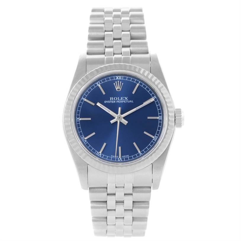 The image shows a front view of the Rolex Oyster Perpetual Mid-Size model, highlighting its blue dial and silver bracelet.