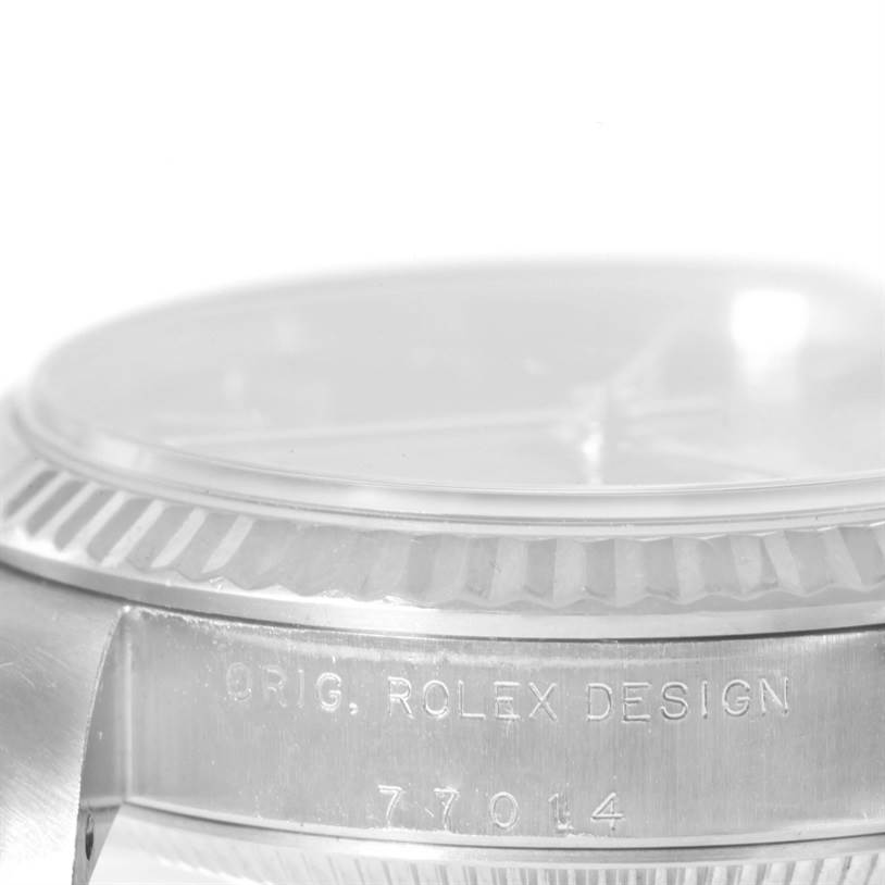 This image shows a close-up of the side of a Mid-Size Rolex watch, highlighting the engraved bezel and case with the model number 77014.