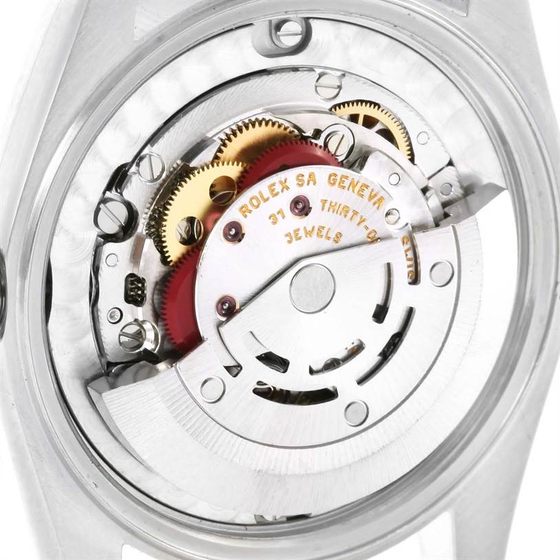 This image shows a close-up view of the movement parts and internal mechanics of a Mid-Size Rolex watch.