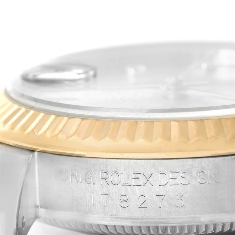 The image shows a close-up side view of a Rolex Mid-Size 178273 Women's Steel and Gold (two tone) Silver Dial 178273 Women's Steel and Gold (two tone) Silver Dial watch, focusing on the fluted bezel and model number engraving.