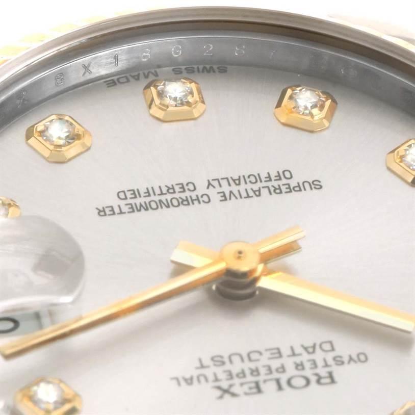 The image shows a close-up angle of the dial, hands, and part of the bezel of a Mid-Size Rolex watch.
