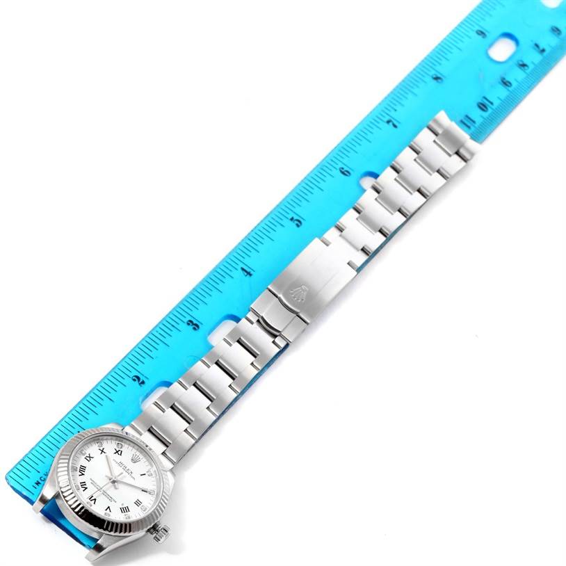 The image shows a flat-lay view of a Rolex Mid-Size 177234WRDO Women's Stainless Steel White Dial 177234WRDO Women's Stainless Steel White Dial watch with a ruler measuring the length of its metal bracelet.