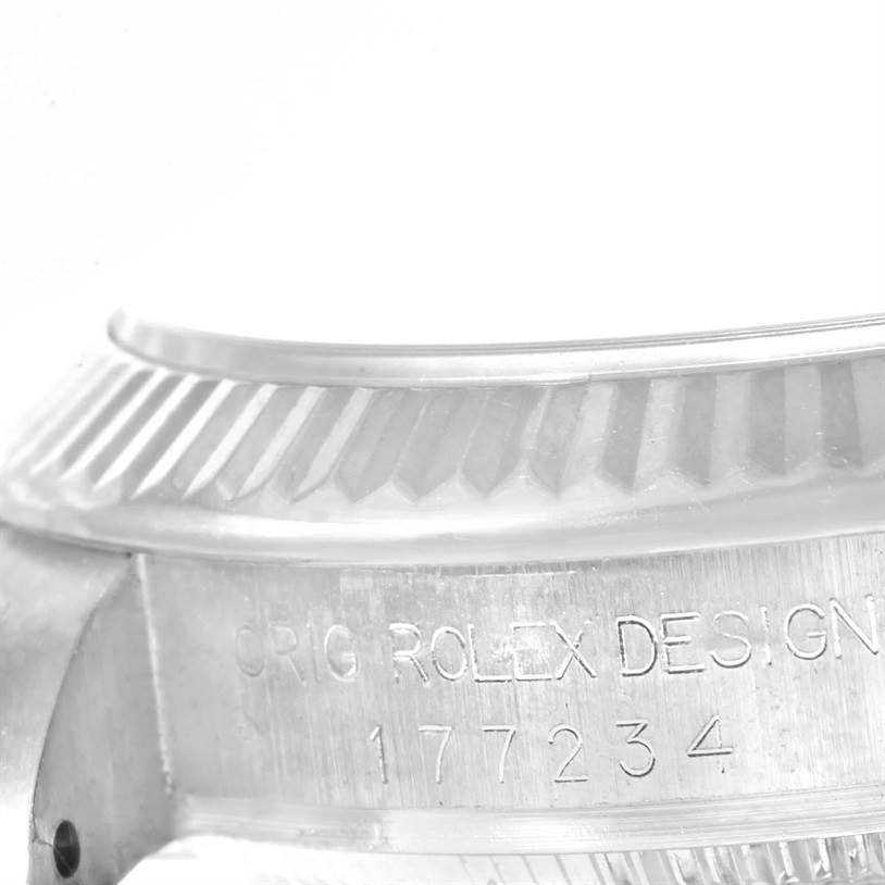 The image shows a close-up of the bezel and case side of a Rolex Mid-Size 177234WRDO Women's Stainless Steel White Dial 177234WRDO Women's Stainless Steel White Dial model with an engraved serial number.